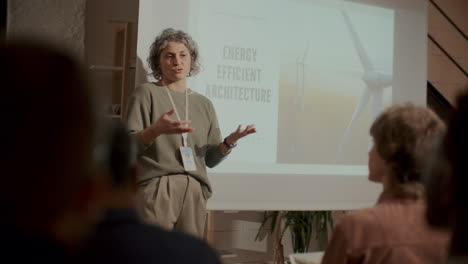 female speaker presenting energy efficient architecture at conference