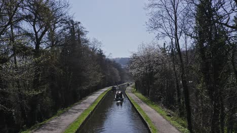 A-Narrow-Boat-heading-up-stream-after-Crossing-the-Pontcysyllte-Aqueduct,-famously-designed-by-Thomas-Telford,-located-in-the-beautiful-Welsh-countryside,-famous-Llangollen-Canal-route