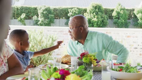 Video-of-african-american-family-spending-time-together-and-having-dinner-outside