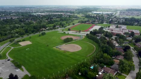 Drone-flying-over-a-running-track,-baseball-diamond-and-soccer-field-in-Milton