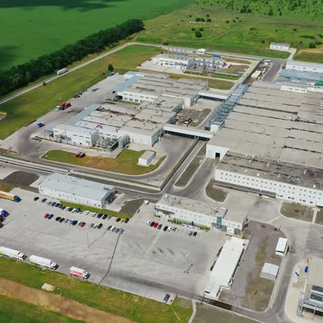 industrial area in the countryside. exterior of modern manufacture on beautiful green environment background. aerial view.