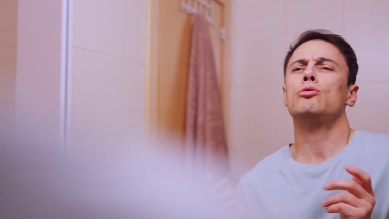 Narcissistic man admiring himself in bathroom mirror