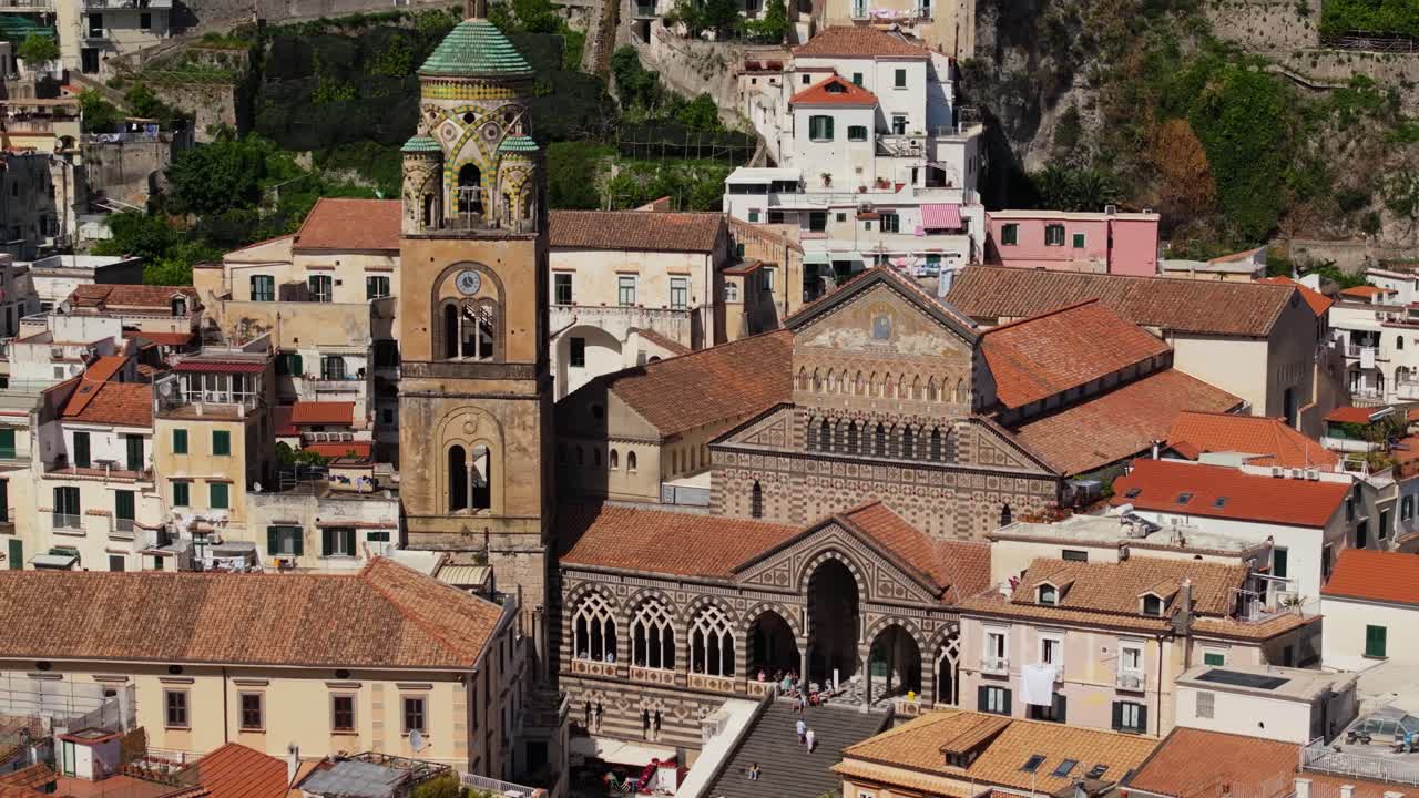 drone disparado hacia adelante sobre la catedral de amalfi en un típico día de verano en la ciudad de playa italiana