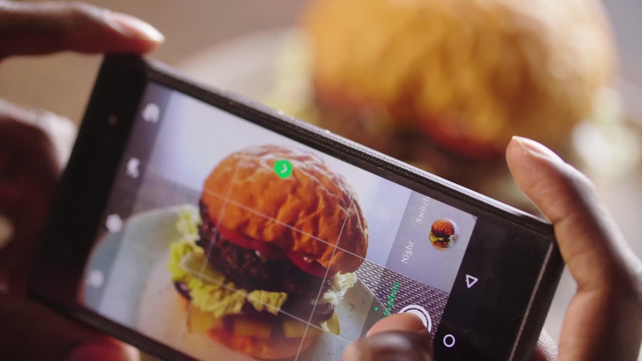 Taking a picture of a delicious burger with a smartphone
