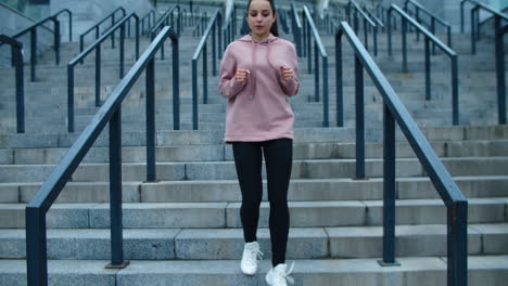 fit woman running down stairs in slow motion. athlete woman relaxing after run