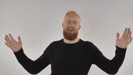 redhead guy having fun, dancing in front of camera