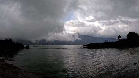 Timelapse-of-vapor-clouds-rolling-over-lake-at-dusk,-Kintamani,-Bali