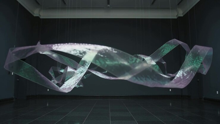 Floating hung ribbon sculpture slowly reshaping gallery as suspension lines shifting
