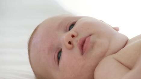 baby lying on a bed