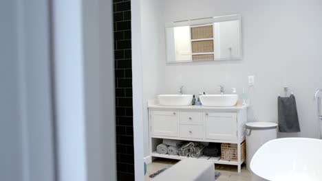 general view of bathroom with bathtub at home, mirror and washbasin, slow motion