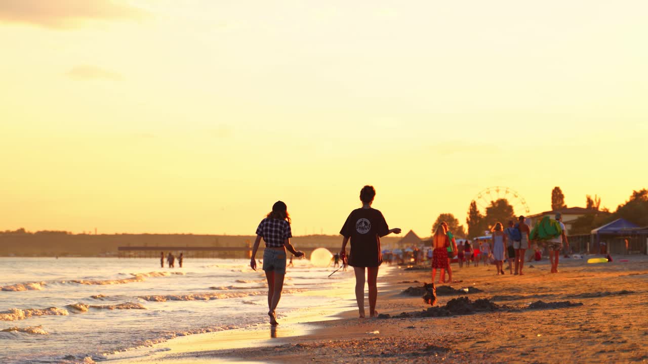 People walking along beach. Happy young people enjoying at beach