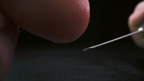 el investigador toca la aguja con la vacuna antiviral con el dedo