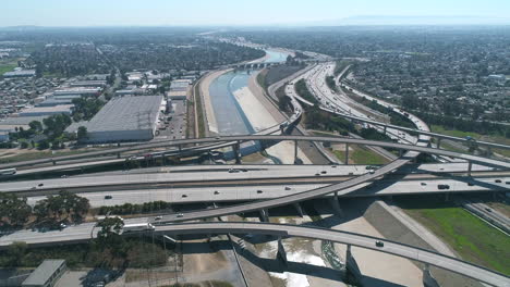 aerial drone shot of 710 interstate over the la river in california with cars on highway