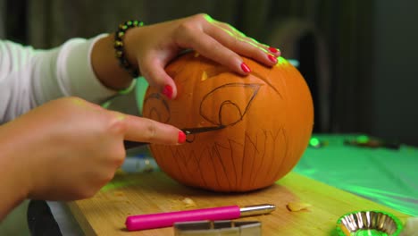 Carving eye on pumpkin during thunder indoor