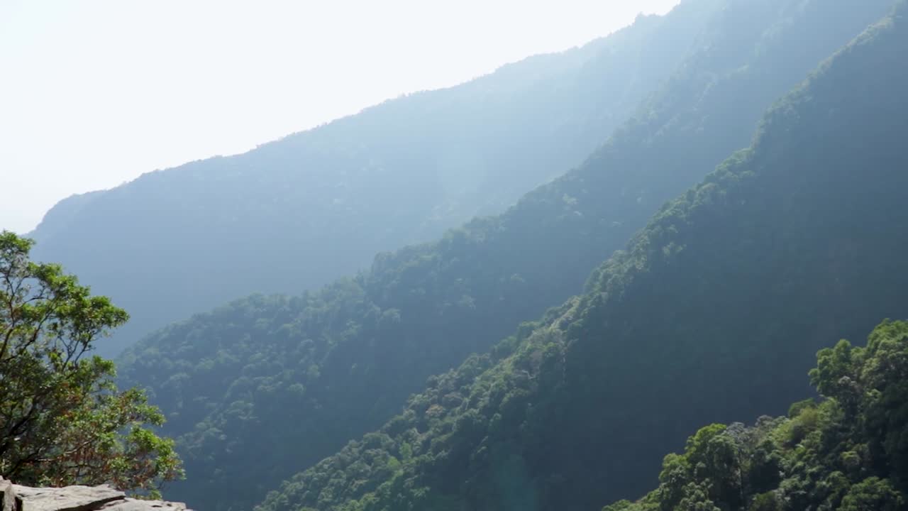 꼭대기 각도에서 산 절벽의 자연 수영장에서 깨끗한 전망을 즐기는 남자