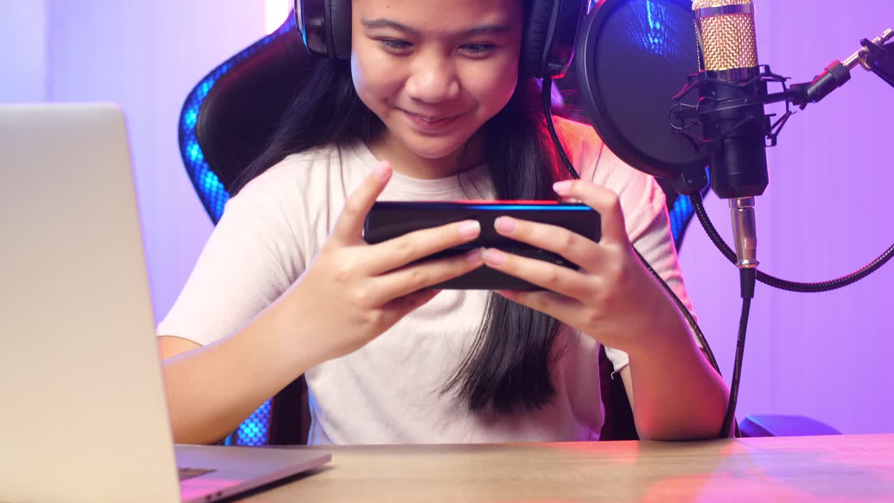 Excited Asian Kid Girl Playing Video Game With Mobile Phone While Live Stream