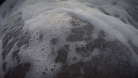 huge waves roll in and crash against a rocky shoreline 2