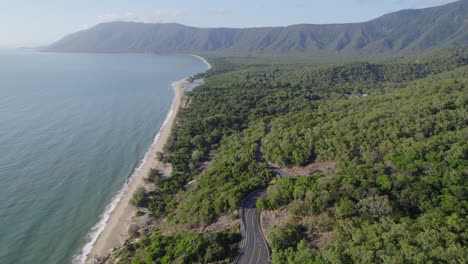 aerial view over lush vegetation and scenic ocean around rex lookout in north queensland, australia - drone shot