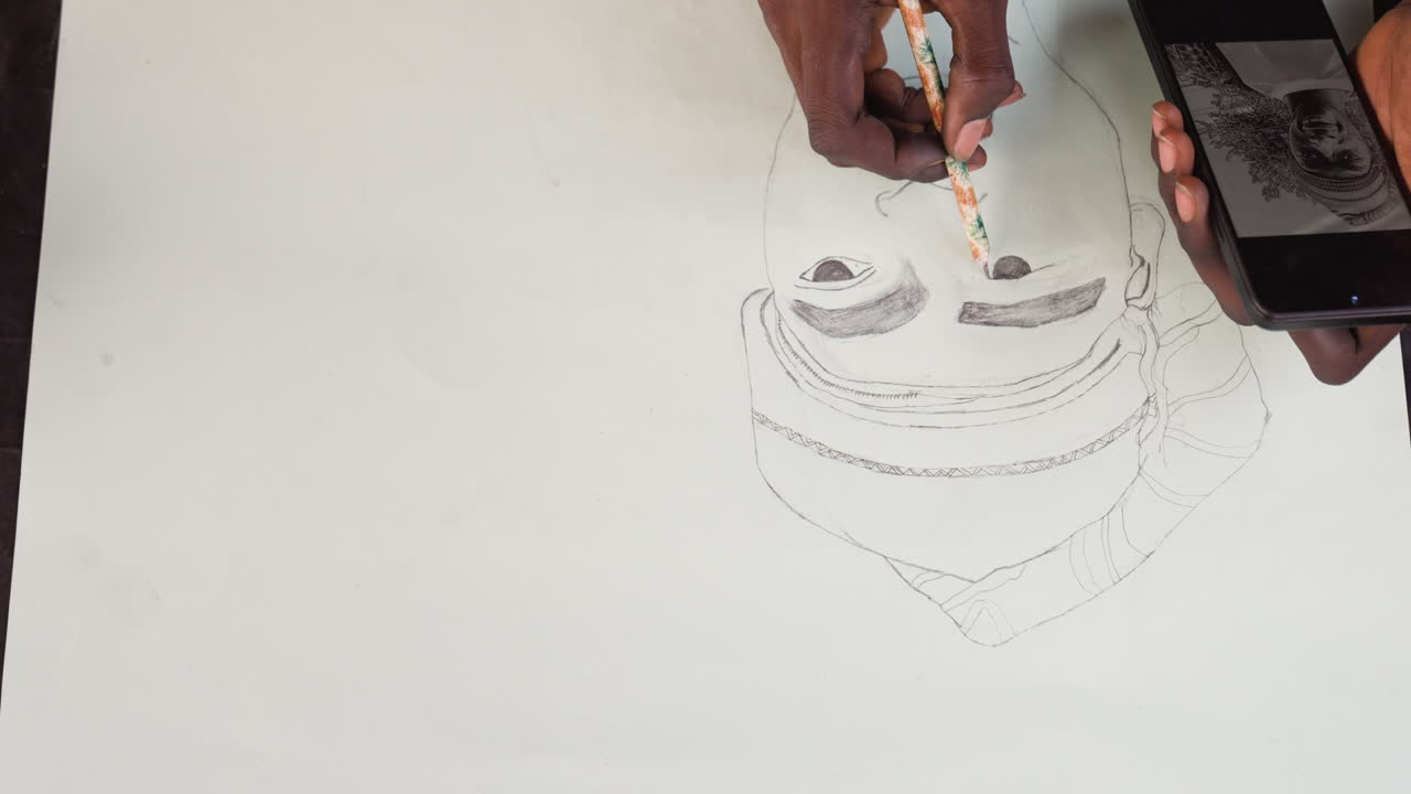 Black designer tracing portrait layout with phone reference, overhead desk view shows meticulous dotted outline, measured pencil strokes and clean workspace, neutral lighting and methodical workflow