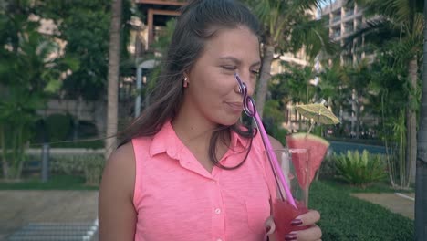 woman-in-pink-clothing-with-long-hair-drinks-tasty-beverage