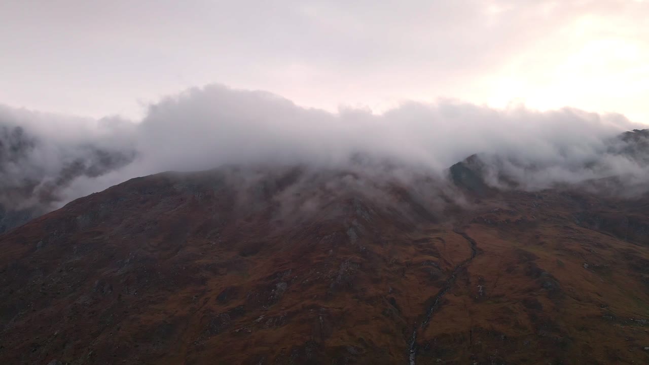 Mountain Top With Clouds And Fog During Sunrise In Piedmont, Italy - aerial sideways
