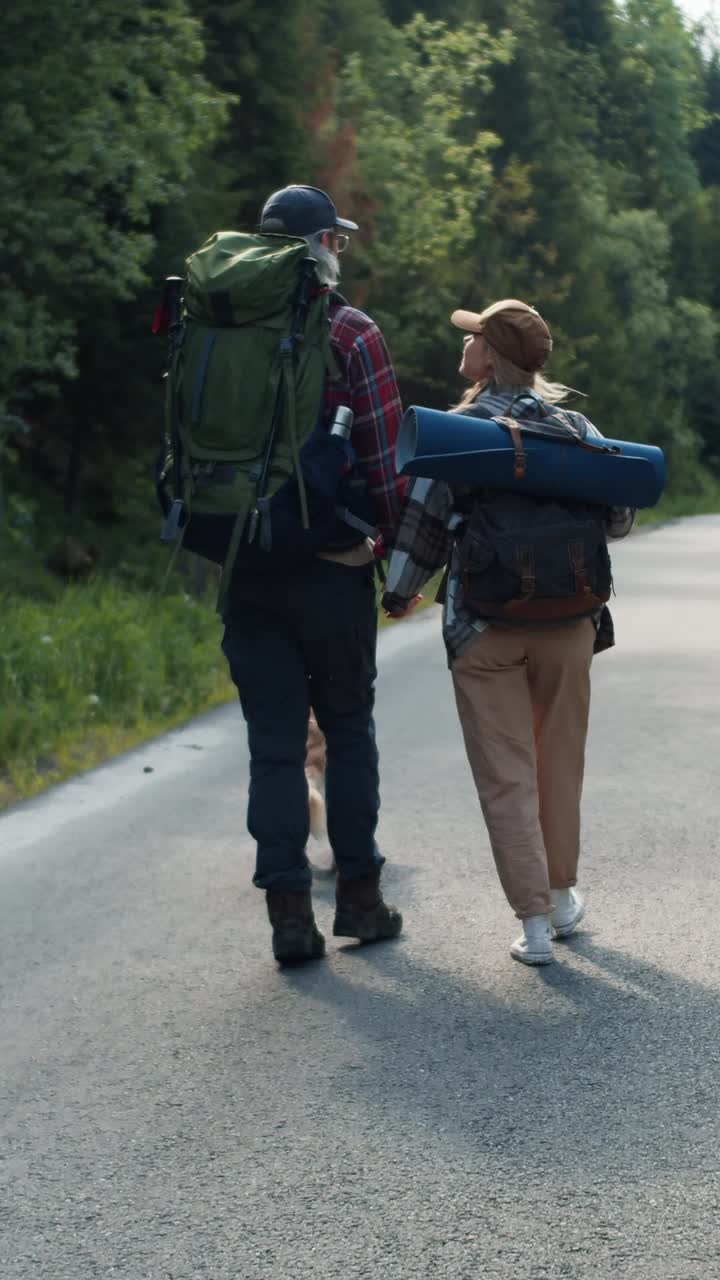 Couple Hiking in Forest with Dog