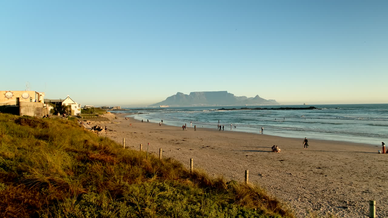 Sunset view from wooden stairs at Bloubergstrand Big Bay beach of Table Mountain