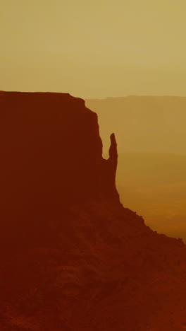 dramatic silhouette of a red rock formation in monument valley