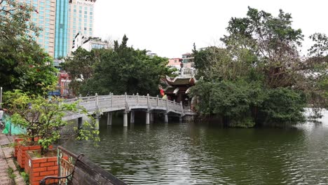 bridge and temple amidst lush greenery