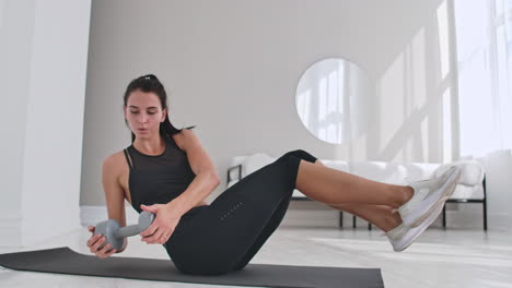 profile side view photo portrait of charming gorgeous sporty sportive concentrated beautiful with ponytail brunette lady doing crunches on purple carpet at the weekend leading healthy lifestyle