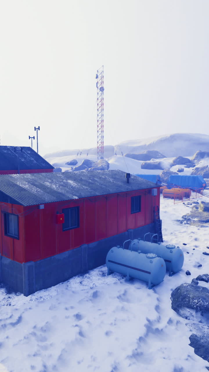 Scenic view of research station in snowy landscape with rocky terrain