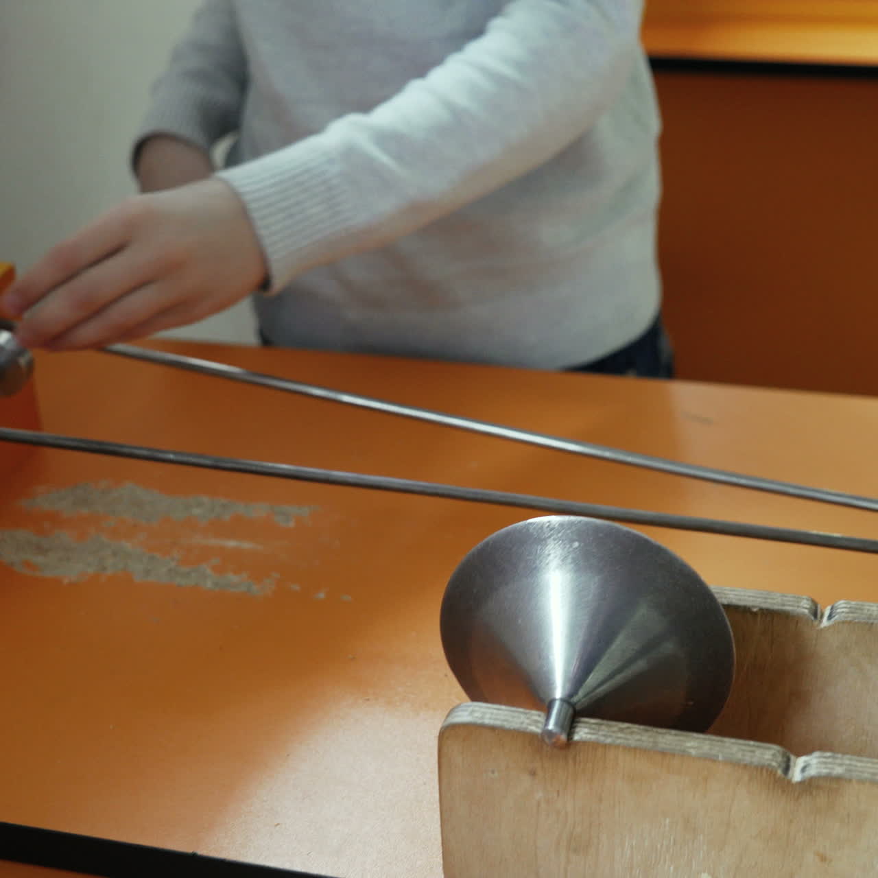 Boy is playing with a metal cone. Museum of entertaining sciences Square video