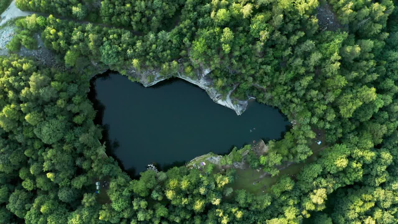 Aerial drone zoom out shot of a lake in an old quarry called Rampa in Czech republic