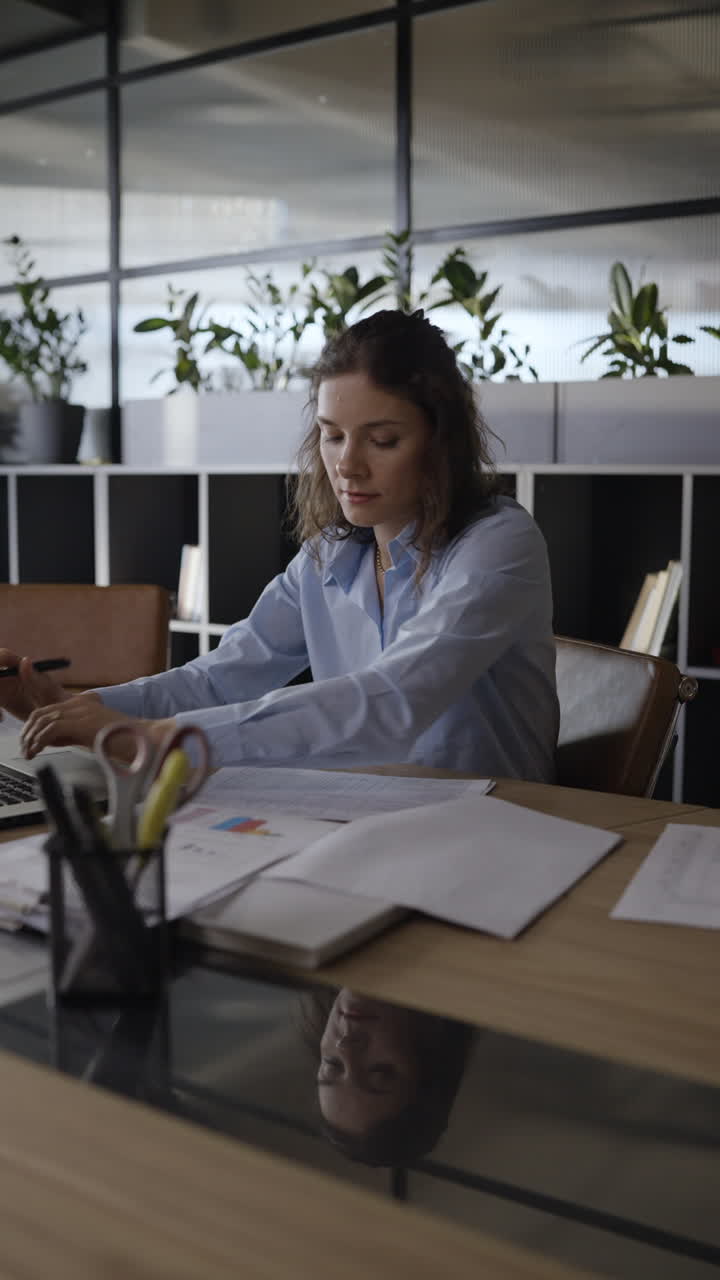 Woman Working on Laptop in Office