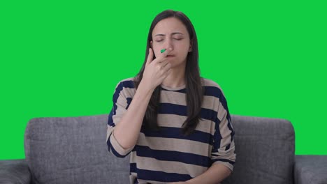 sick indian girl checking fever green screen