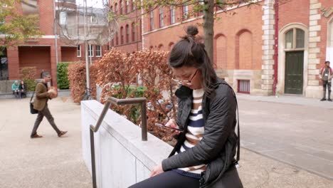 Handheld-Shot-of-Young-Woman-Staring-Intently-at-Her-Phone