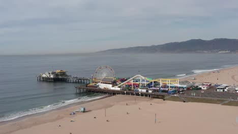 aerial flyover shot tilting down on the santa monica pier during the covid-19 pandemic