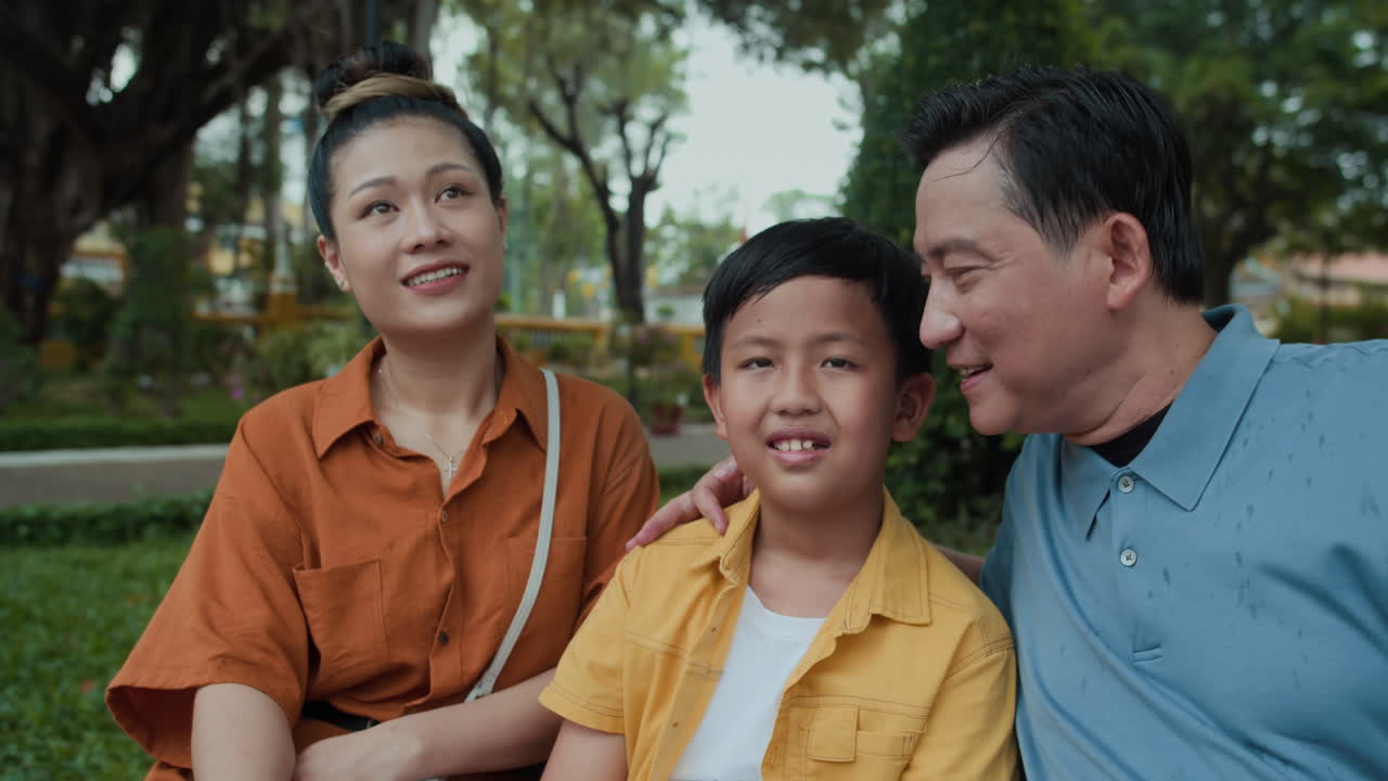 Parents and Son Resting and Talking after Walk