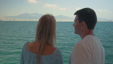 Woman-and-man-speaking-on-boat-against-sea-landscape-Piraeus-Greece