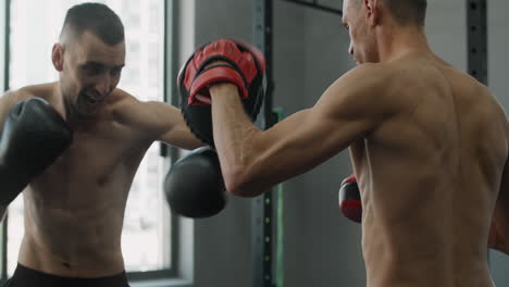two men boxing in a gym