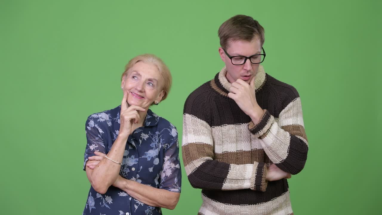 Happy grandmother and worried grandson thinking together