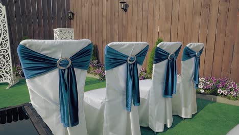 beautifully decorated chairs preparation for the celebration passing camera along