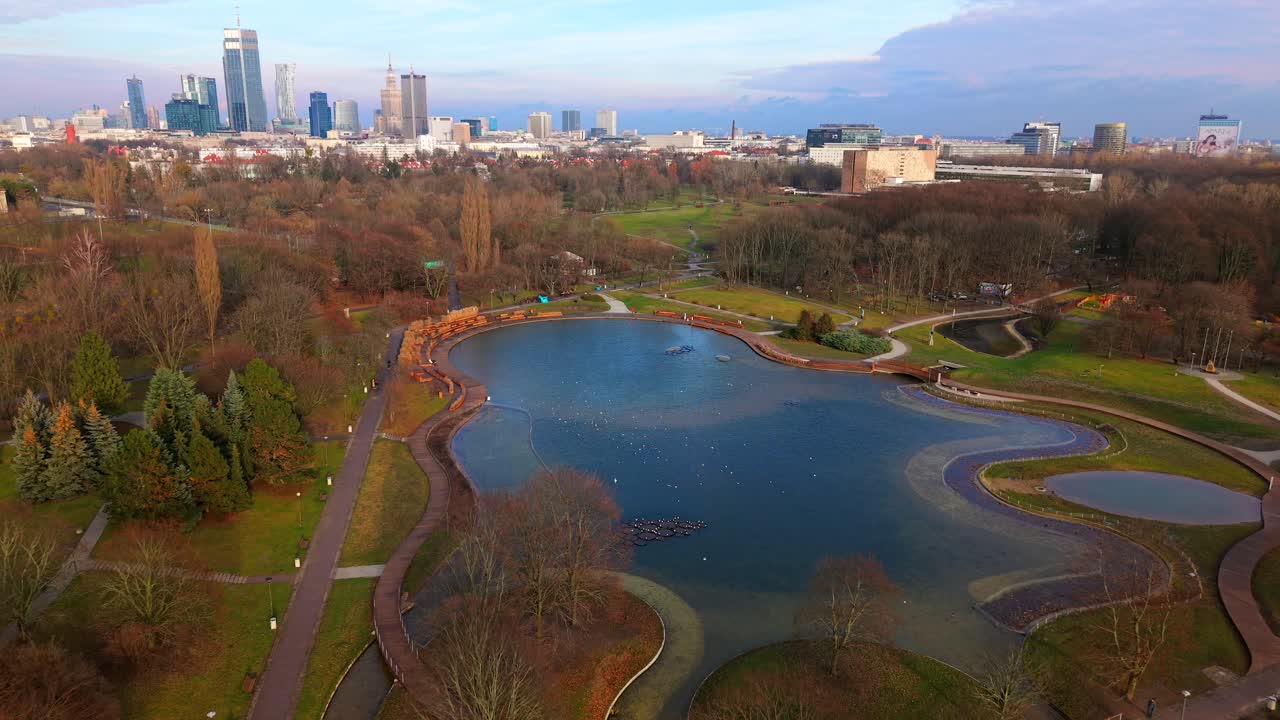 Warsaw skyline with modern buildings and pola mokotowskie park ponds, aerial view