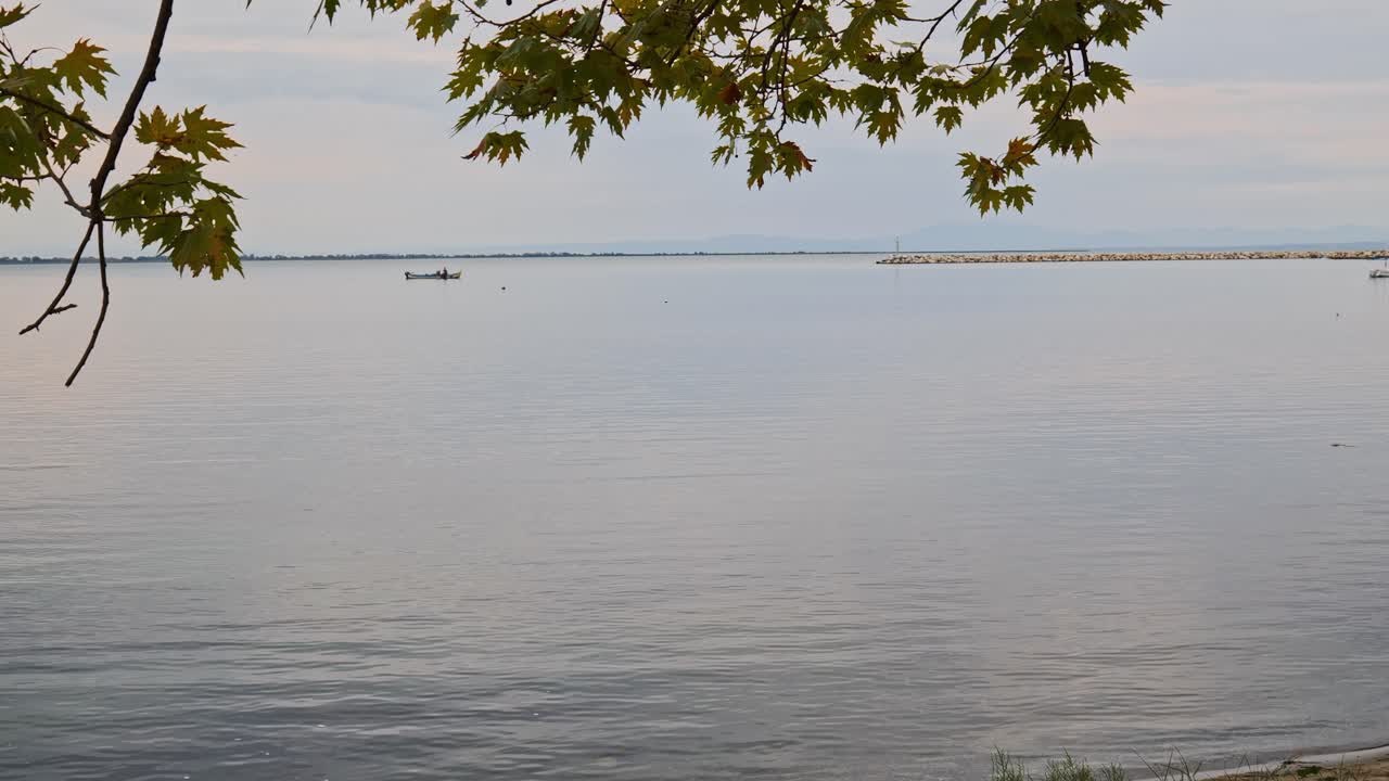 Distant Fishing boat peaceful calm Greek sea twilight scene