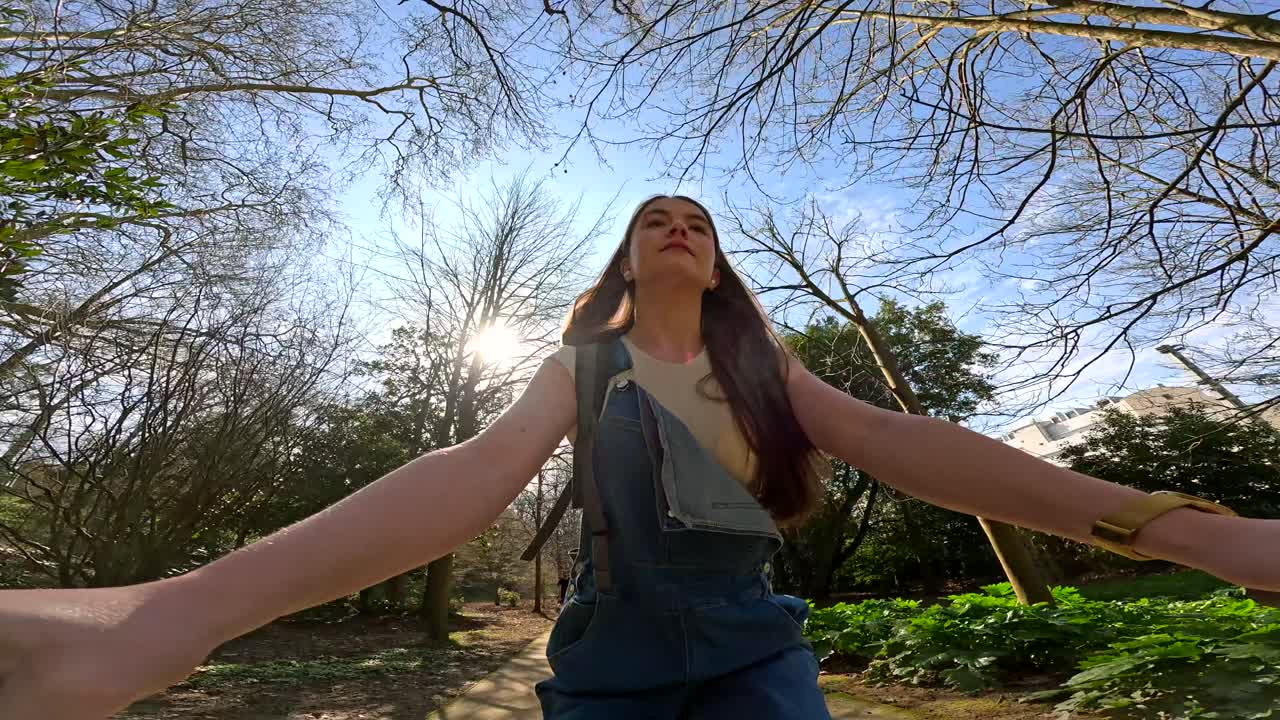 Woman Enjoying Nature in a Park on a Sunny Day