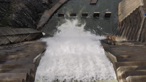 top down medium view of water flowing through the hinze dam overflow due to ongoing heavy rains in the gold coast hinterland