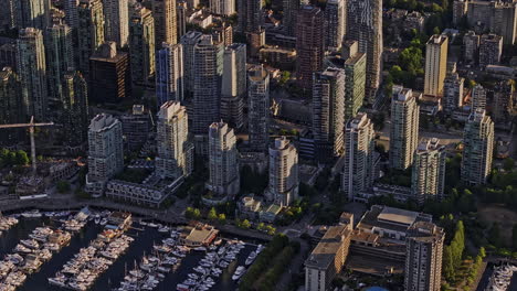 vancouver bc canada aerial v54 zoomed birds eye view drone flyover coal harbour marina capturing waterfront downtown cityscape with towering skyscrapers - shot with mavic 3 pro cine - july 2023