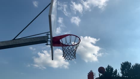 orange basketball flies to the basket with net