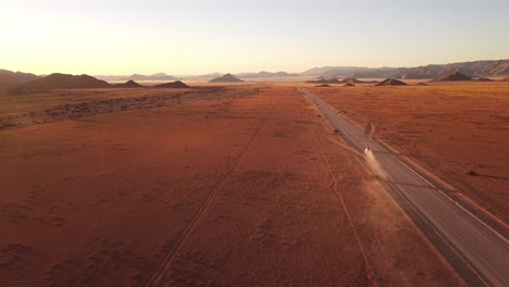 Namibian-self-drive-wildlife-adventure-with-a-rooftop-tent-equipped-Toyota-Hilux-in-Sossusvlei's-iconic-sand-dunes-at-sunset