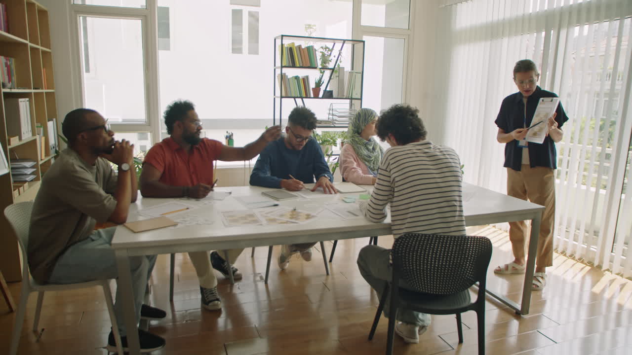 Female Teacher Explaining Lesson to Diverse Immigrant Students